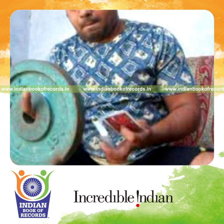individual performing muse card cuts in one minute while holding weight plate for record in Indian Book of Records