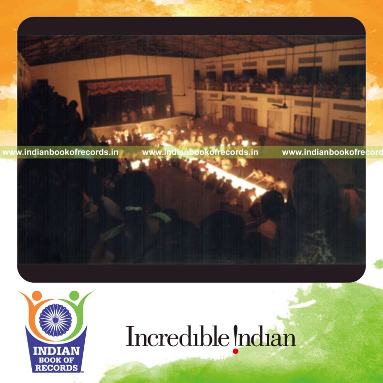 candles arranged and lit in a cross image at single venue for record in Indian Book of Records