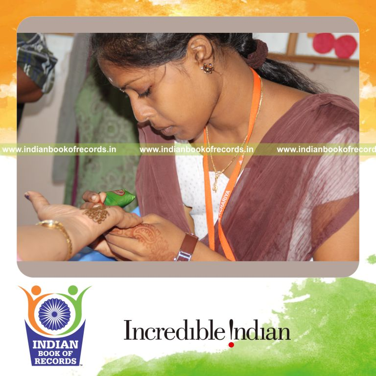 female individual creating multiple henna arts within ten hours for record in Indian Book of Records