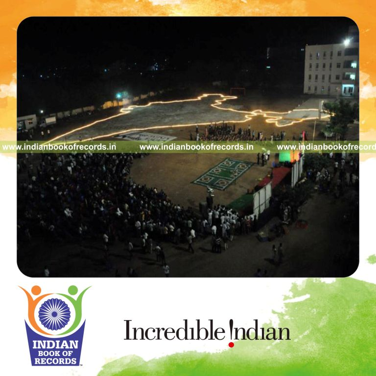 team arranging lit mud lamps to form flaming image for record in Indian Book of Records