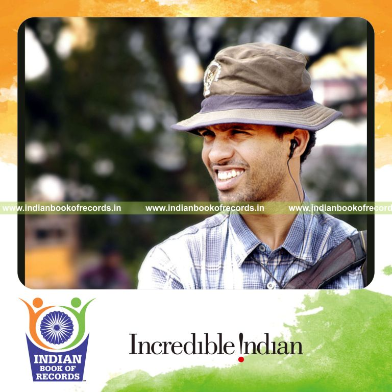 male individual collecting multiple news images for record in Indian Book of Records