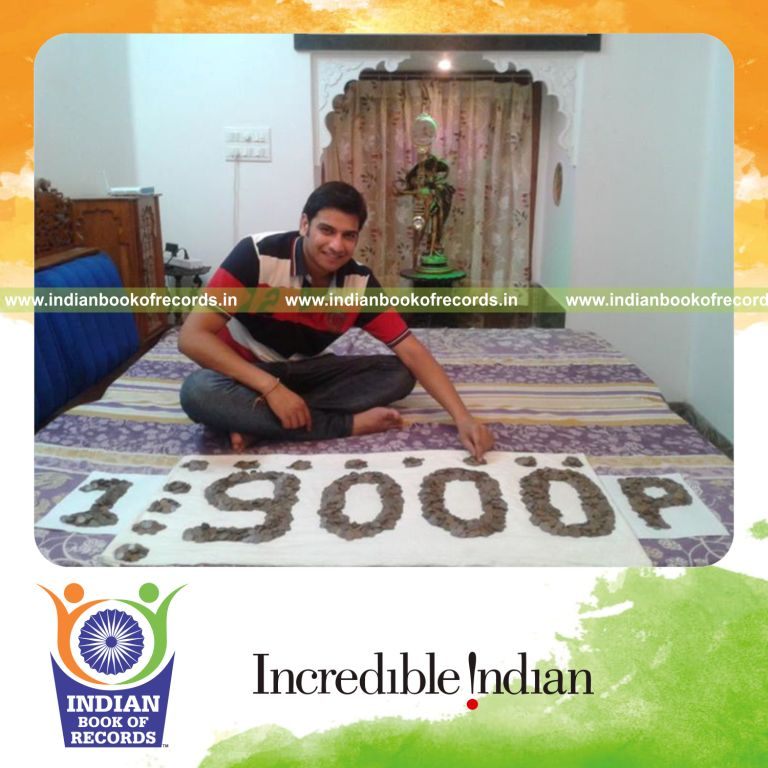 male individual collecting one paisa coins for record in Indian Book of Records