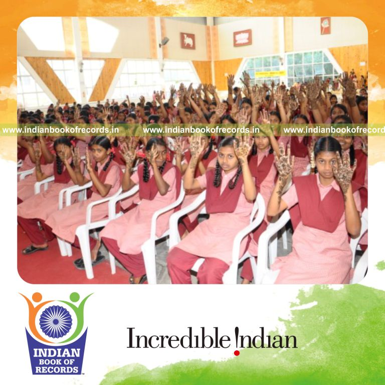 group of people applying mehandi simultaneously at single venue for record in Indian Book of Records