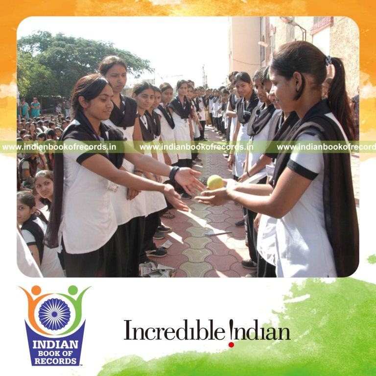 group of people catching cricket ball in relay at single venue for record in Indian Book of Records