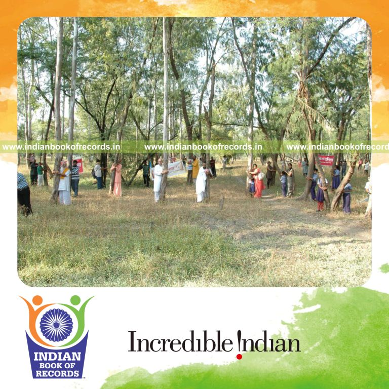 group of people hugging trees simultaneously at single venue for record in Indian Book of Records