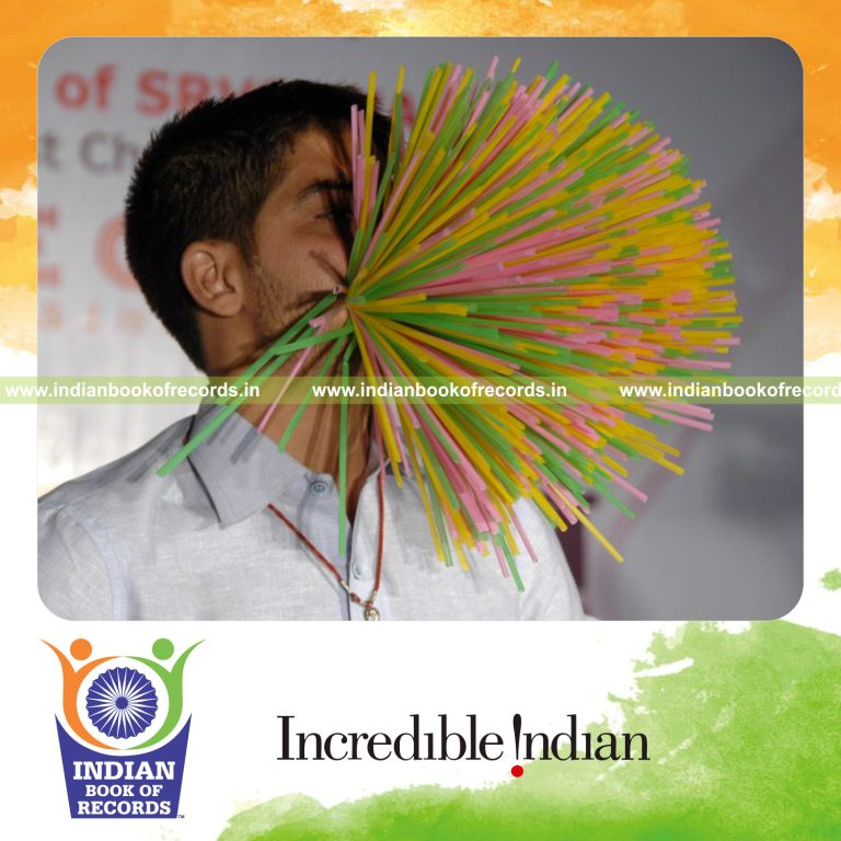 male individual stuffing multiple straws in mouth for record in Indian Book of Records