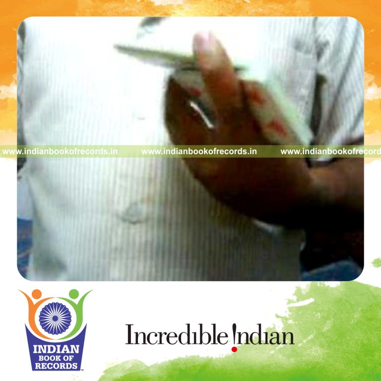 individual performing maximum one handed revolution cuts in one minute for record in Indian Book of Records