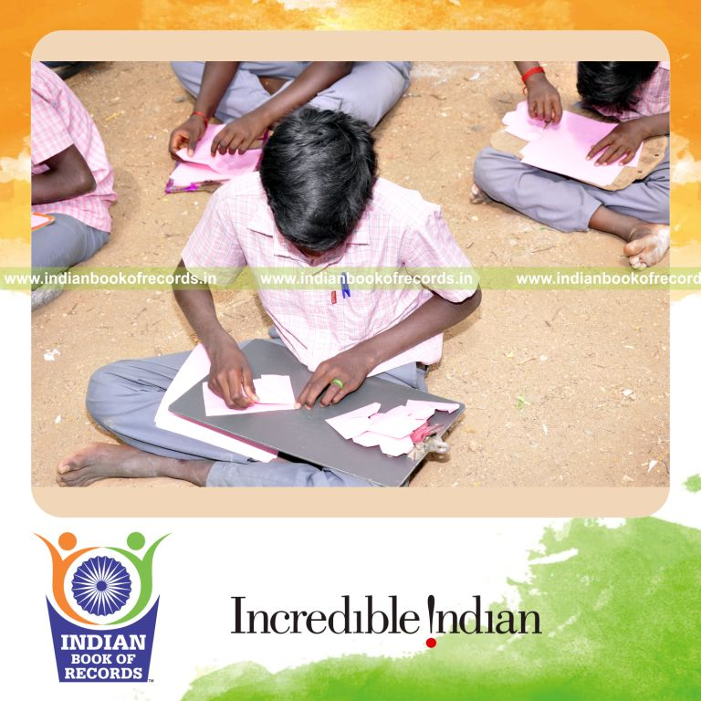 a team creating origami heart models within thirty minutes in a coordinated activity for a record in Indian Book of Records