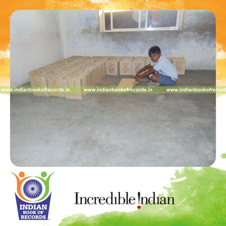minor male making and coloring paper bags within 6 hours for Indian Book of Records
