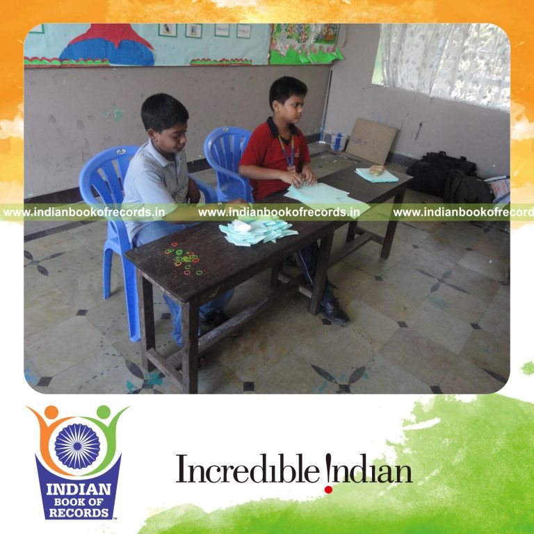 young male making paper boats within six hours for record in Indian Book of Records