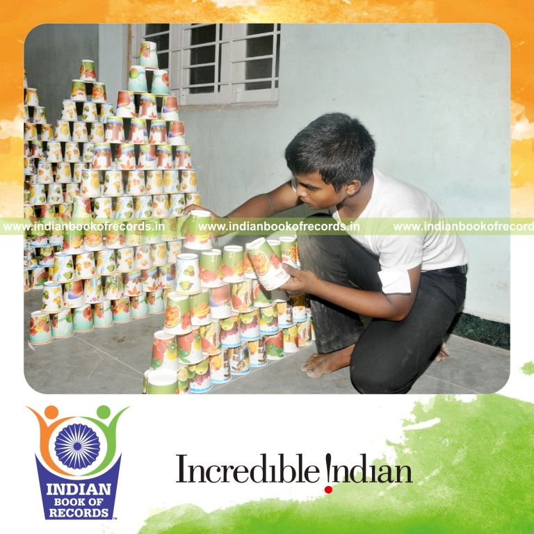 young male making paper cup pyramids within three hours for record in Indian Book of Records