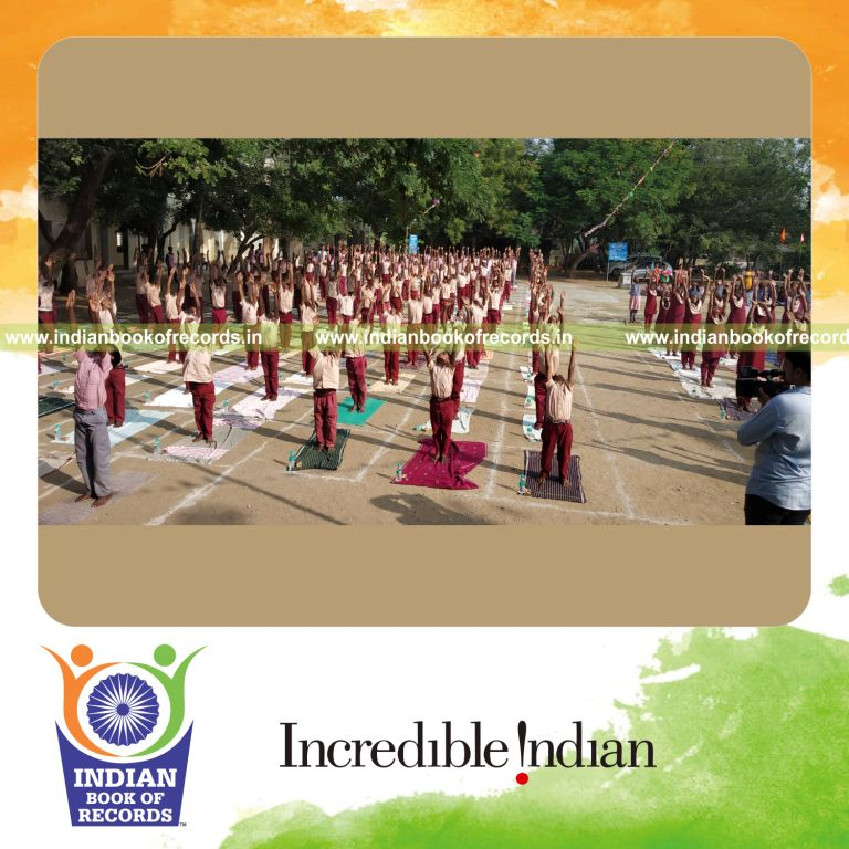 people performing surya namaskara together at the same time in a coordinated yoga activity for a record in Indian Book of Records