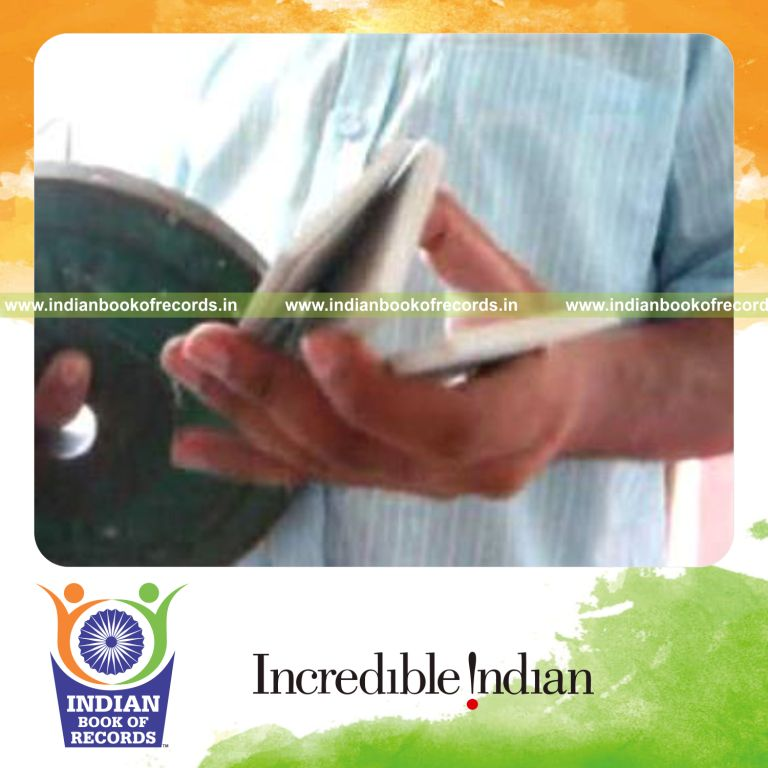 individual performing pre cmc cuts while holding weight plate for record in Indian Book of Records