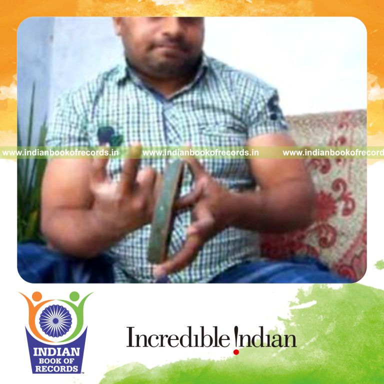 individual performing pre cmc card cuts while holding weight plates for record in Indian Book of Records