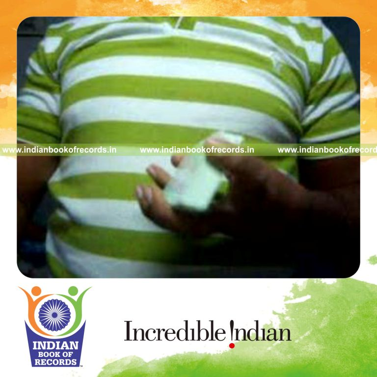 individual performing maximum reverse scissor card cuts in 30 seconds for record in Indian Book of Records