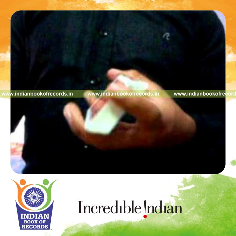 individual performing maximum reverse scissor card cuts in one minute for record in Indian Book of Records