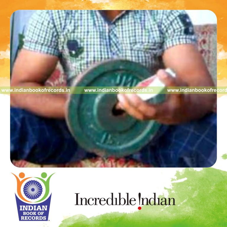 individual performing reverse scissor card cuts while holding weight plates for record in Indian Book of Records