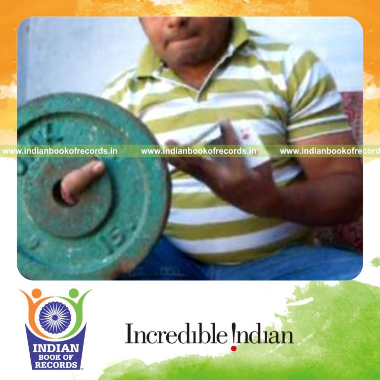 individual performing revolution card cuts in one minute while holding weight plate for record in Indian Book of Records