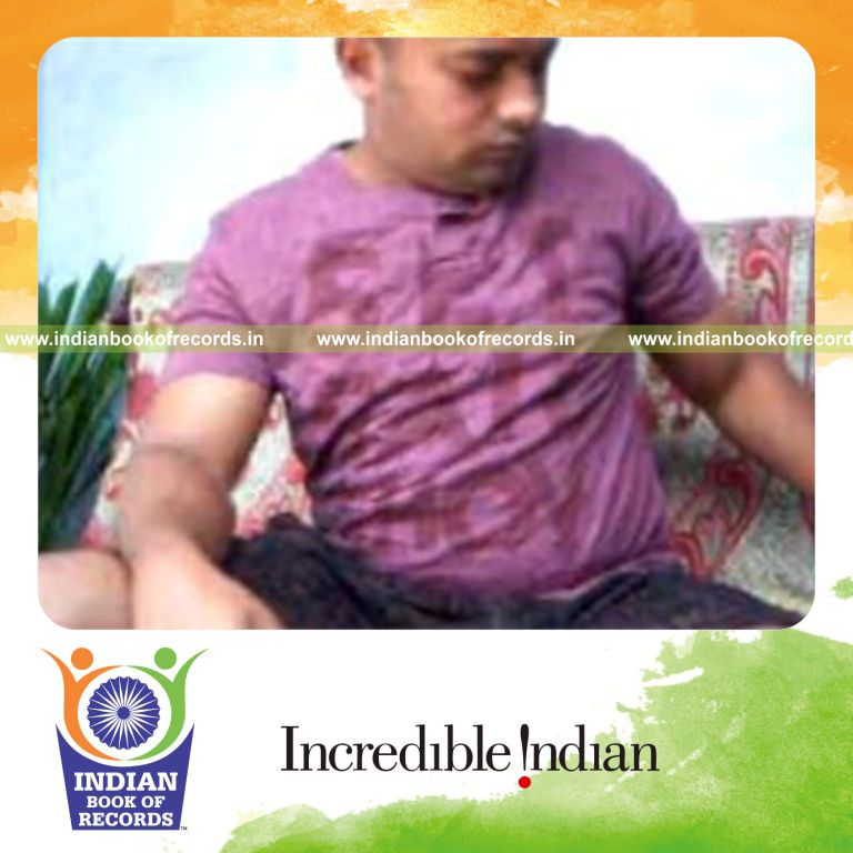 individual performing revolution 2 card cuts while holding 20 pound weight plate for record in Indian Book of Records