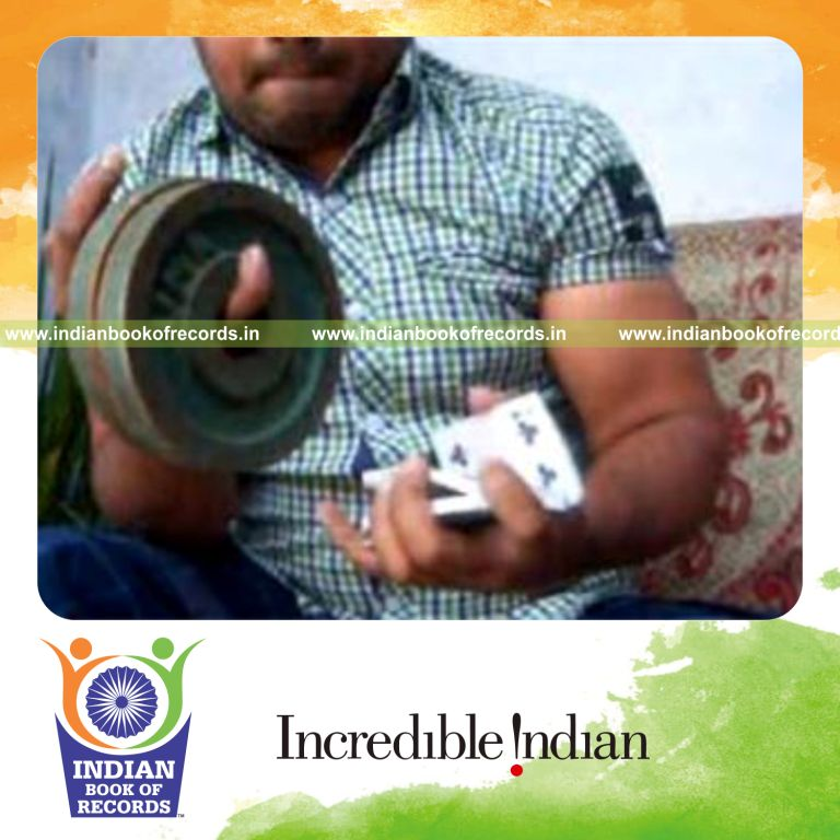 individual performing revolution 2 card cuts while holding weight plates for record in Indian Book of Records