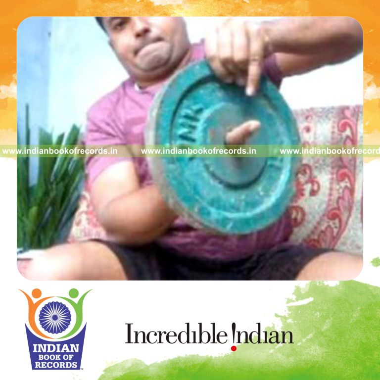 individual performing sabers rollback card cuts while holding 20 pound weight plate for record in Indian Book of Records