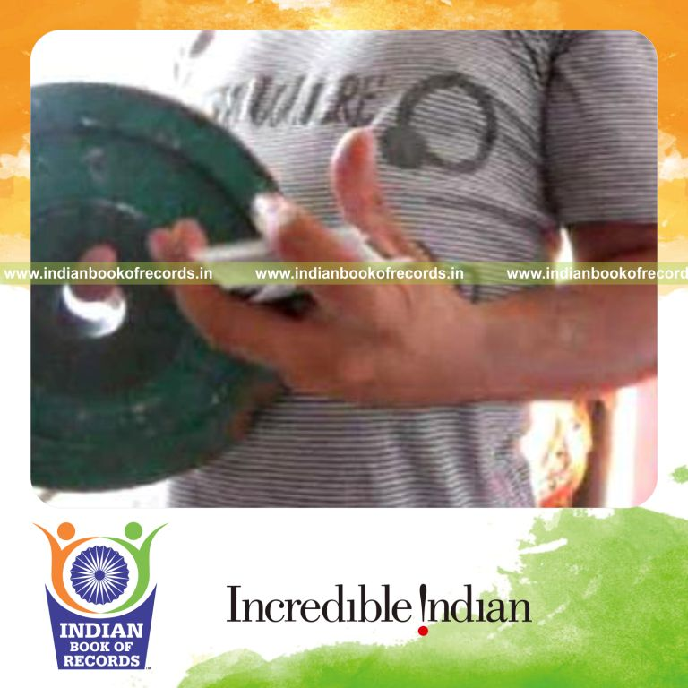 individual performing sabers rollback cuts while holding weight plate for record in Indian Book of Records
