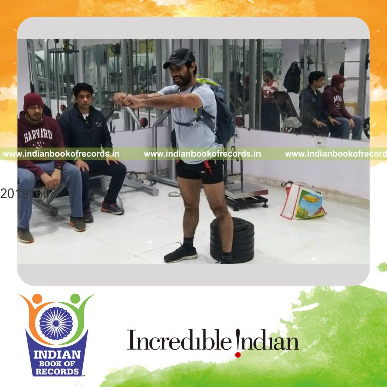 an individual performing squats continuously while carrying an 80 pounds load within one minute for a record in Indian Book of Records