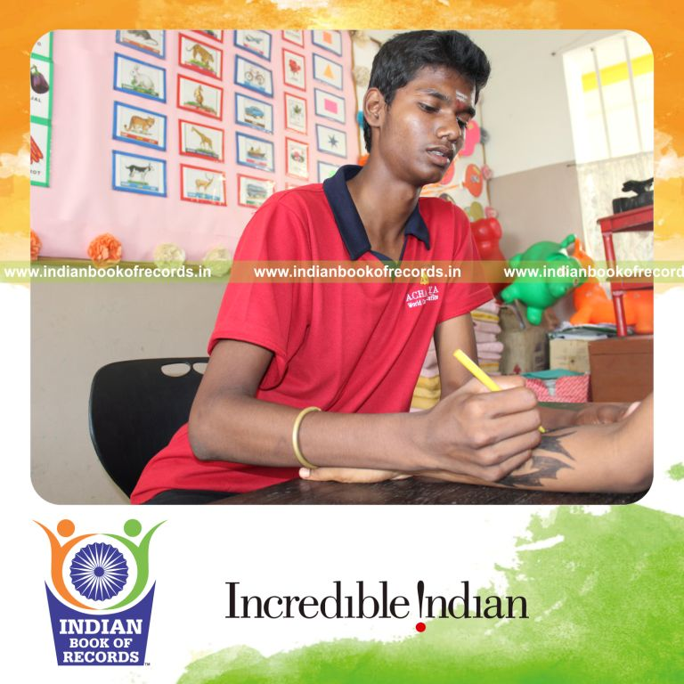 young male painting tattoos within six hours for record in Indian Book of Records