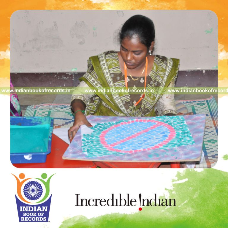 female individual creating multiple thumbprint paintings within ten hours for record in Indian Book of Records