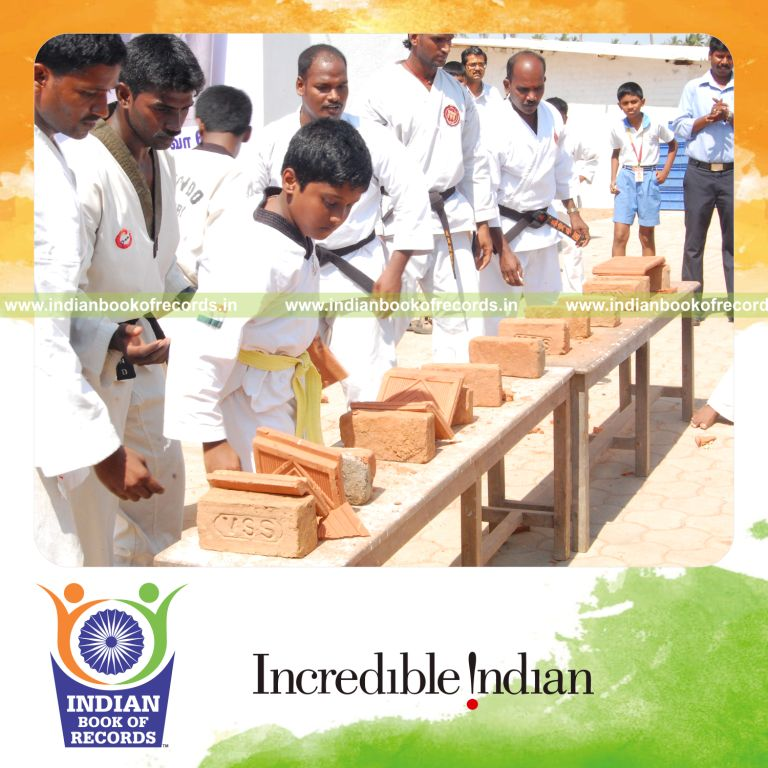 young male breaking tiles with bare hands within ten minutes for record in Indian Book of Records
