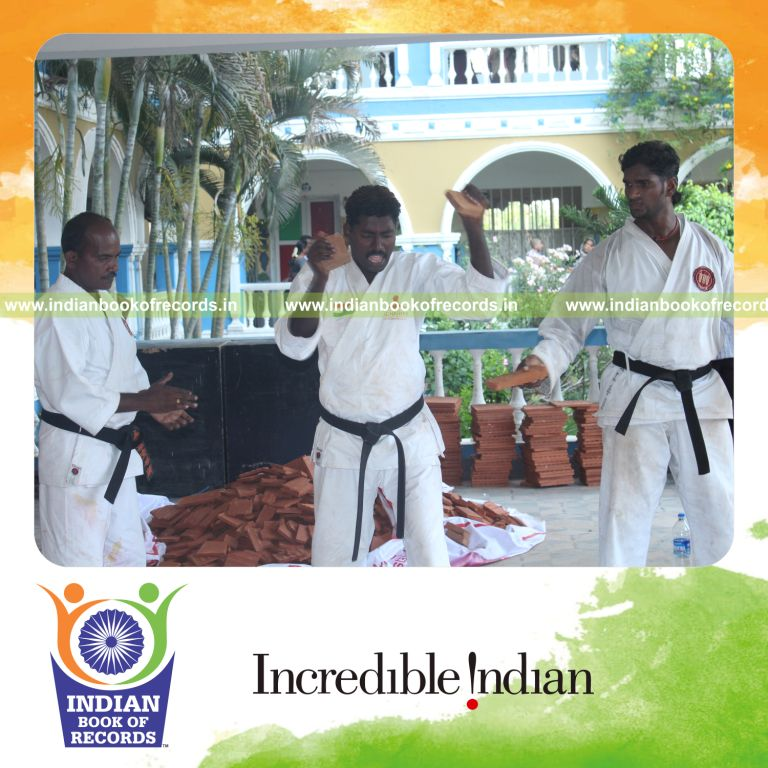 male individual breaking tiles using forehead within thirty minutes for record in Indian Book of Records