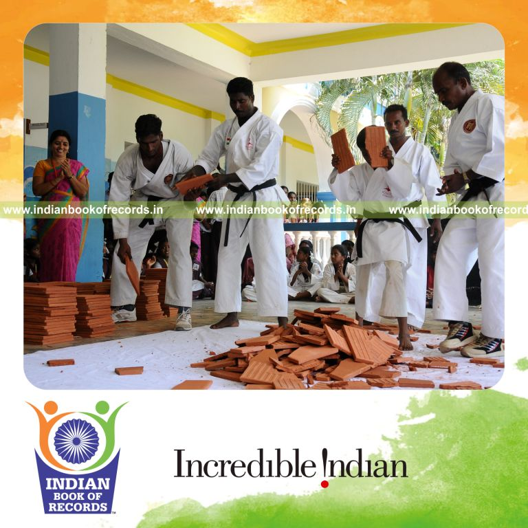 young male breaking tiles using forehead within thirty minutes for record in Indian Book of Records