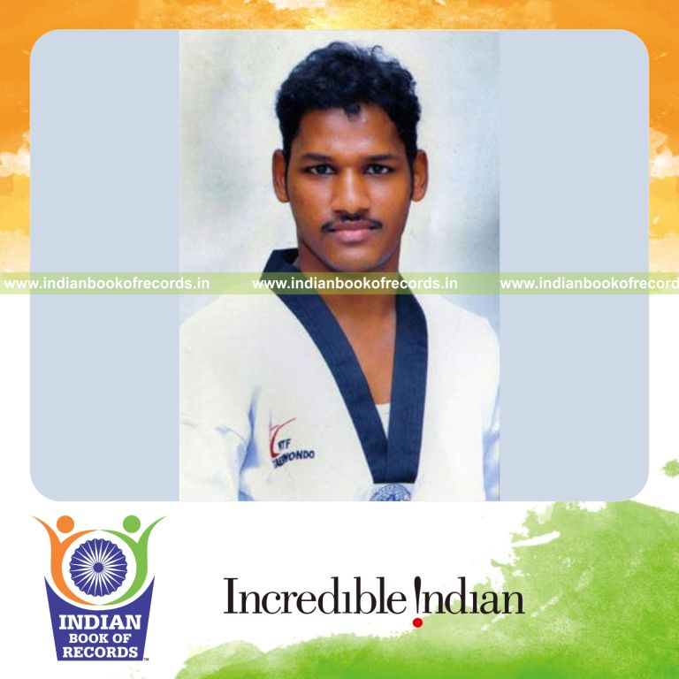 male individual breaking tiles using high reverse kick while blindfolded for record in Indian Book of Records