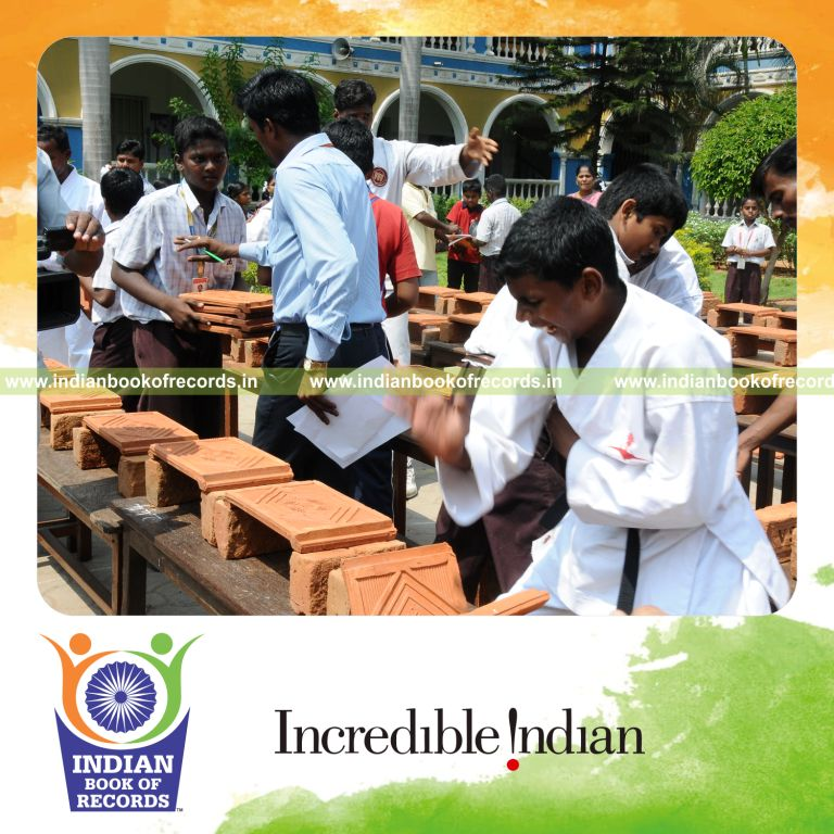 young male breaking tiles using shito blocks within thirty minutes for record in Indian Book of Records