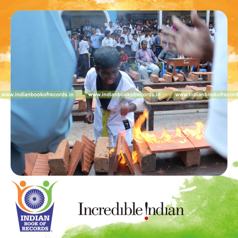 young male breaking tiles on fire within thirty minutes for record in Indian Book of Records