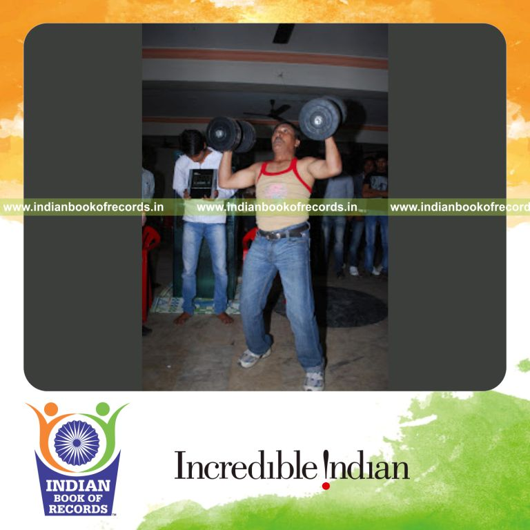 male individual lifting dumbbells repeatedly within one minute for record in Indian Book of Records