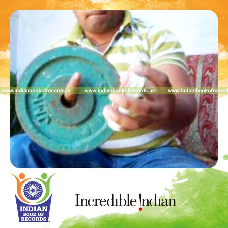 individual performing triangle card cuts in one minute while holding weight plate for record in Indian Book of Records