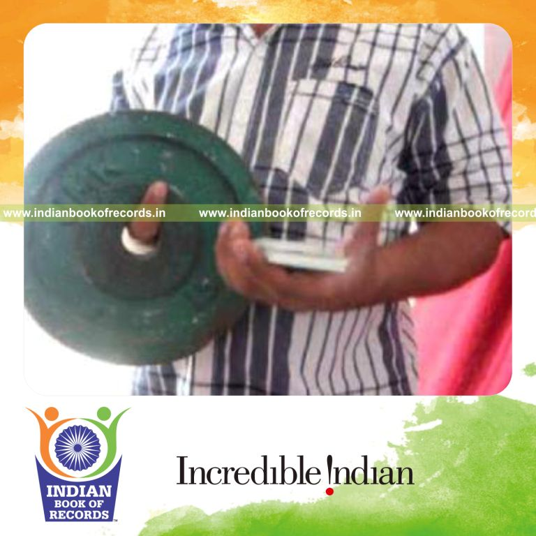 individual performing triangle cuts while holding weight plate for record in Indian Book of Records