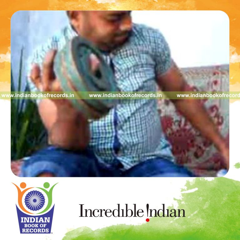 individual performing triangle card cuts while holding weight plates for record in Indian Book of Records