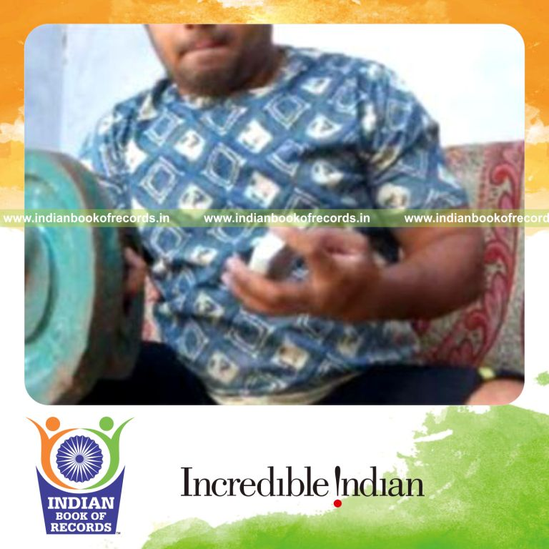 individual performing triple charlier card cuts while holding weight plates for record in an Indian Book of Records