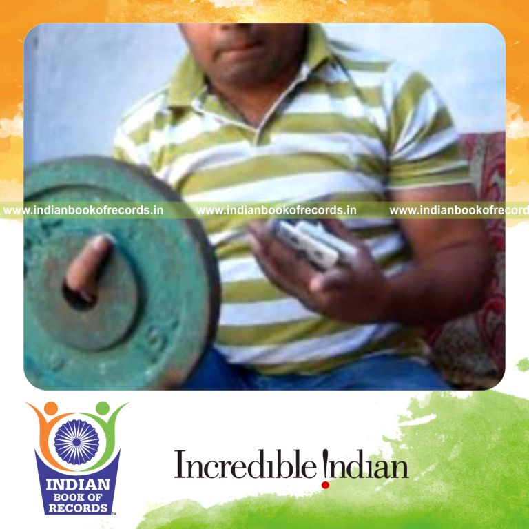 individual performing triple charlier card cuts in one minute while holding weight plate for record in Indian Book of Records