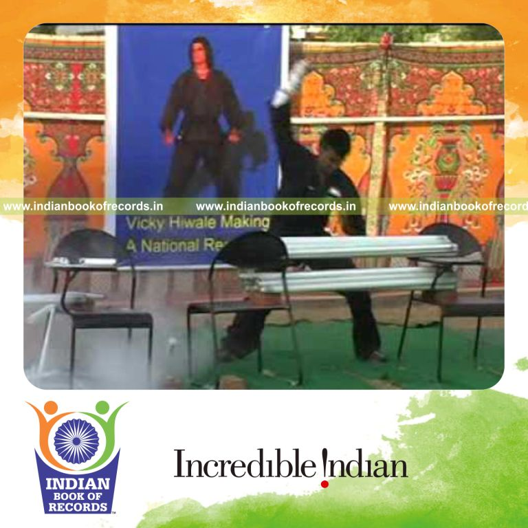 male individual breaking multiple tubelights on head for record in Indian Book of Records