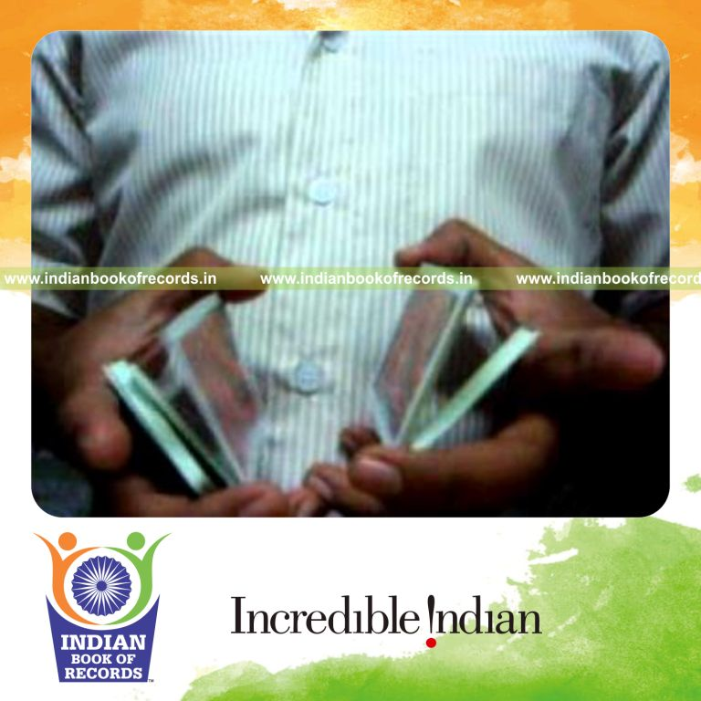 individual performing maximum two handed muse card cuts in 30 seconds for record in Indian Book of Records