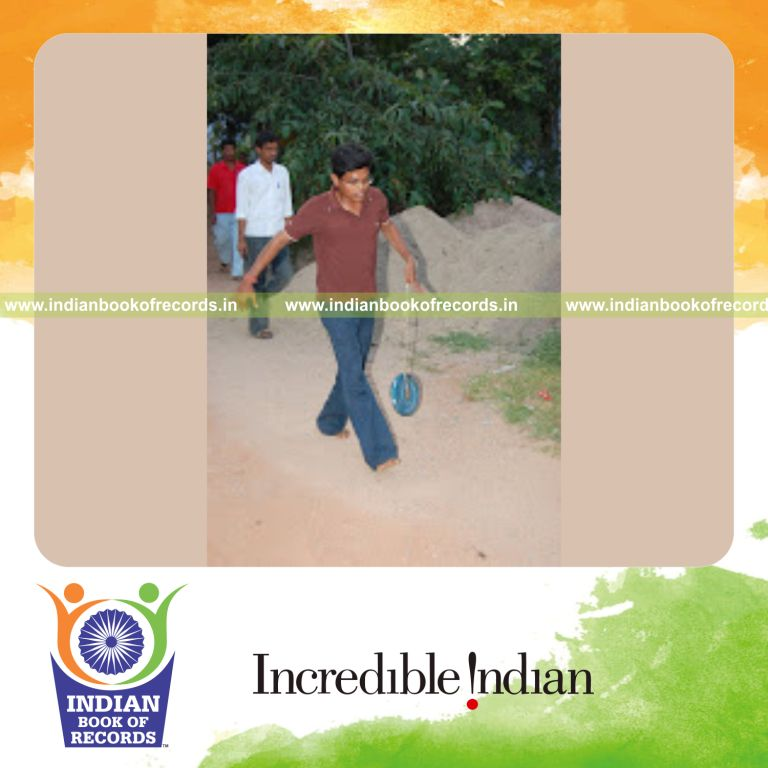 male individual lifting weight using thumb for record achievement in Indian Book of Records
