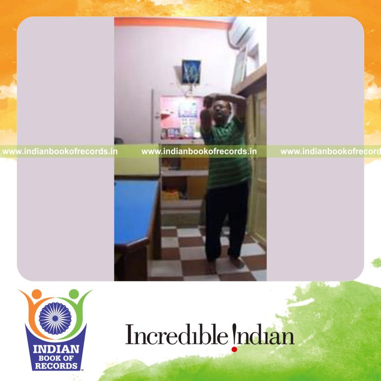 individual balancing wheat thins on elbow and catching them for record in Indian Book of Records