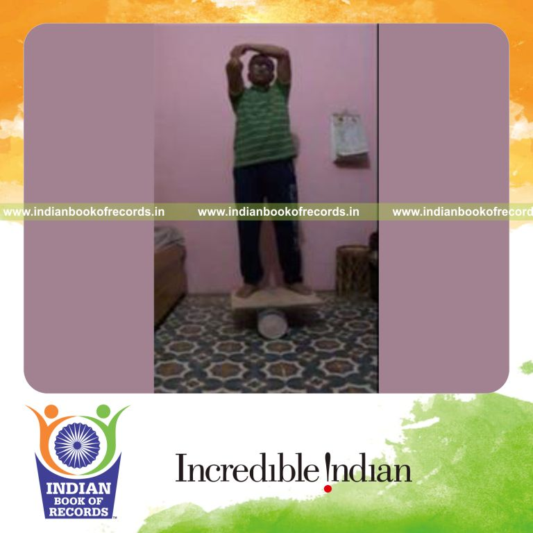 individual balancing wheat thins on elbow and catching while on rola bola for record in Indian Book of Records