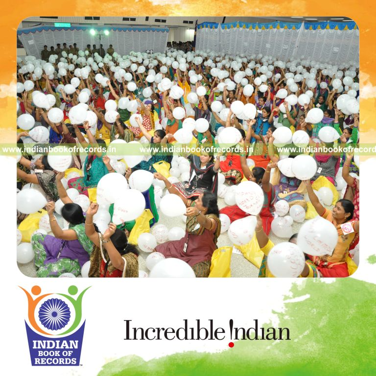 group of women blowing balloons and writing captions for Indian Book of Records