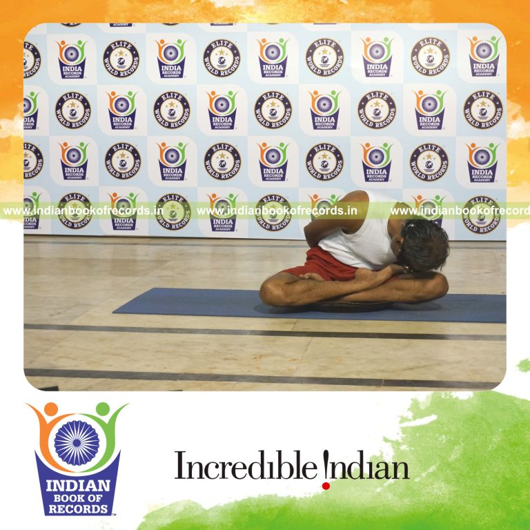 individual performing maximum yogasanas blindfolded on a brass plate in 15 minutes for record in Indian Book of Records