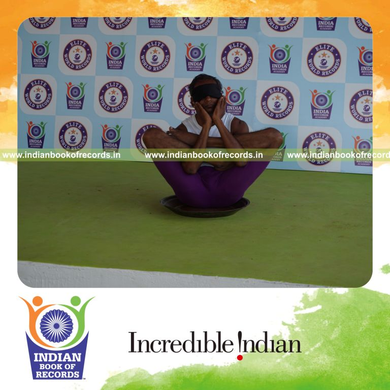 individual performing maximum yogasanas blindfolded on a brass plate in 5 minutes for record in Indian Book of Records