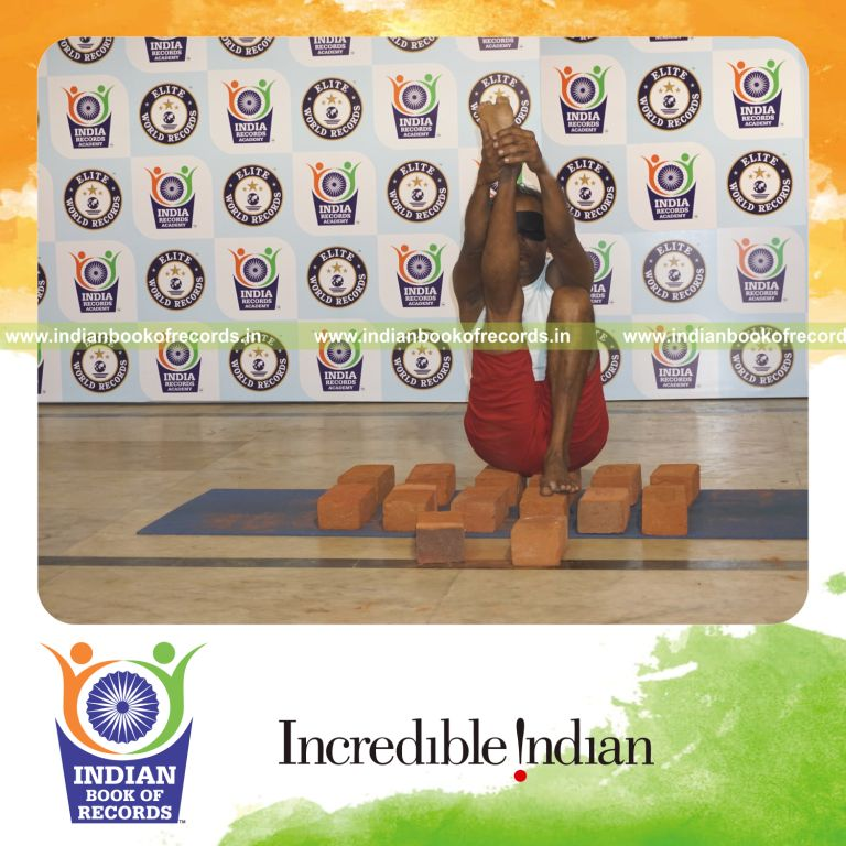 individual performing maximum yogasanas blindfolded on bricks in 10 minutes for record in Indian Book of Records
